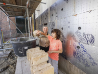 Nieuwe bewoners metselen eerste stenen bij project De Kleine Sluys Poort Dordrecht